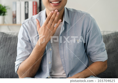 Happy young deaf man using sign Language to communicate with other people.. Happy young deaf man using sign Language to communicate with other people.. 103704625