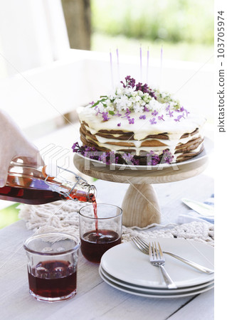 beautiful cake with candles on the background of nature 103705974