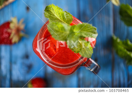 Healthy strawberry smoothie in a glass jar Healthy strawberry smoothie in a glass jar 103708465