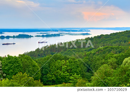 Summer spring evening river Dniper flowing among flowering green hills. Summer spring evening river Dniper flowing among flowering green hills. 103710029