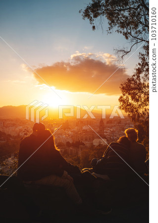 romantic lovely couples watch beautiful sunset in Malaga, Spain 103710160