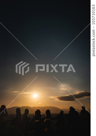 group of people watching sunset at evening, silhouette, dusk, Malaga, Spain group of people watching sunset at evening, silhouette, dusk, Malaga, Spain 103710163