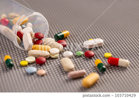 Pills spilled out of the can 103710429