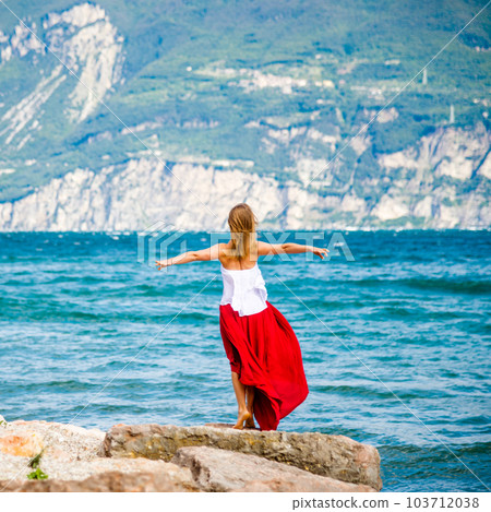 Woman in red dress staying at the lake Woman in red dress staying at the lake 103712038