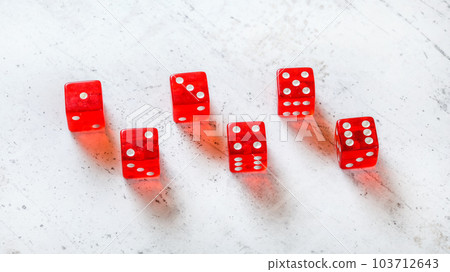 Six red translucent craps dices on white stone like board, showing all numbers from 1 to 6 103712643