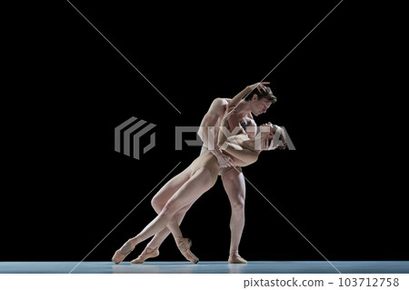 Love and passion. Young people, man and woman, professional ballet dancers making performance against black studio background Love and passion. Young people, man and woman, professional ballet dancers making performance against black studio background 103712758