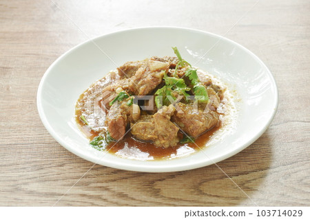 fried pork bone with garlic and pepper salty sauce on plate  103714029