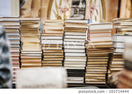 Books stacked on desk in bookstore, abstract education background Books stacked on desk in bookstore, abstract education background 103714444