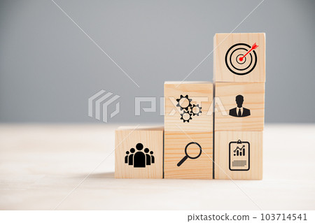 Wooden block cude step on a table with Action Plan, Goal, and Target icons. Success and business target concept. Project management and company strategy for professional growth. Wooden block cude step on a table with Action Plan, Goal, and Target icons. Success and business target concept. Project management and company strategy for professional growth. 103714541