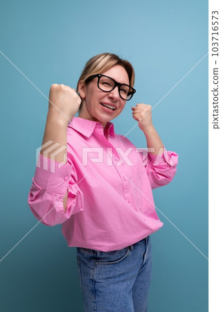young smart blond caucasian secretary woman with glasses and ponytail dressed in a pink blouse 103716573