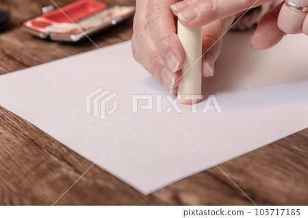 [Woman stamping the stamp with case] 103717185