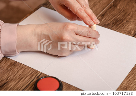 [Woman stamping the seal with vermilion] 103717188