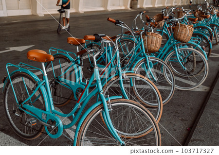 colorful blue bicycles in the parking lot, bike rental. colorful blue bicycles in the parking lot, bike rental. 103717327