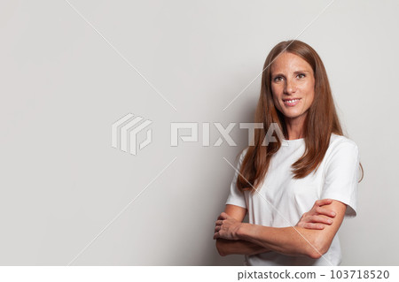 Portrait of confident successful woman with crossed arms standing on white background 103718520