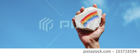 man with a rock with a rainbow flag, banner 103718594