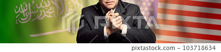 Politician or businessman on background of Saudi Arabia and America flags 103718634