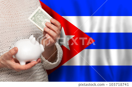 Cuban woman with money bank on the background of Cuba flag. Dotations, pension fund, poverty Cuban woman with money bank on the background of Cuba flag. Dotations, pension fund, poverty 103718741