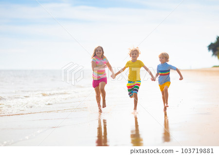 Kids play on tropical beach. Sand and water toy. Kids play on tropical beach. Sand and water toy. 103719881