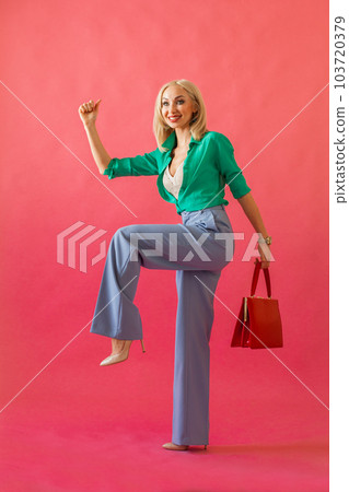Happy woman with red handbag on the pink background, shopping, sale, black friday concept Happy woman with red handbag on the pink background, shopping, sale, black friday concept 103720379