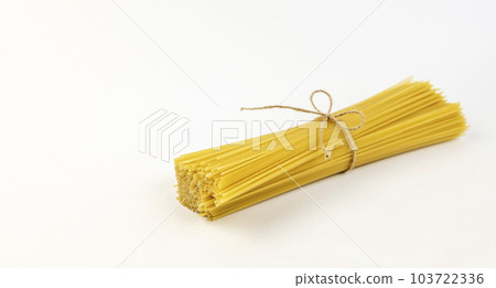 Spaghetti tied with a thread isolated on a white background. Spaghetti tied with a thread isolated on a white background. 103722336