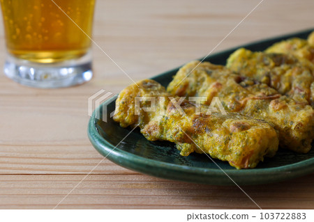 Fried Isobe of curry-flavored chikuwa on a green plate Fried Isobe of curry-flavored chikuwa on a green plate 103722883