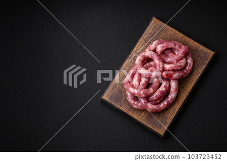 Raw sausages from pork or beef with salt, spices and herbs Raw sausages from pork or beef with salt, spices and herbs 103723452