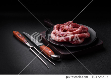 Raw sausages from pork or beef with salt, spices and herbs Raw sausages from pork or beef with salt, spices and herbs 103723493