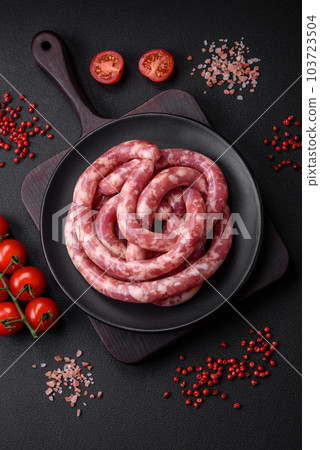 Raw sausages from pork or beef with salt, spices and herbs Raw sausages from pork or beef with salt, spices and herbs 103723504
