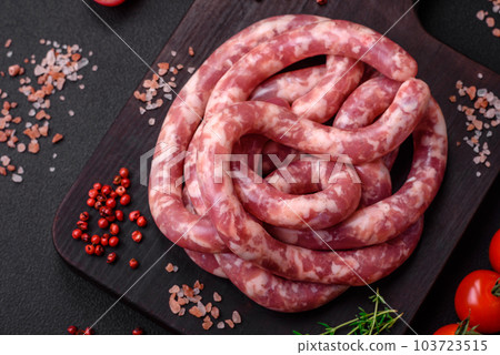 Raw sausages from pork or beef with salt, spices and herbs Raw sausages from pork or beef with salt, spices and herbs 103723515
