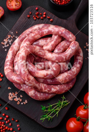 Raw sausages from pork or beef with salt, spices and herbs Raw sausages from pork or beef with salt, spices and herbs 103723516