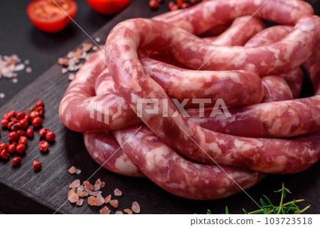Raw sausages from pork or beef with salt, spices and herbs 103723518