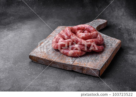 Raw sausages from pork or beef with salt, spices and herbs 103723522