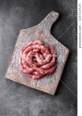 Raw sausages from pork or beef with salt, spices and herbs 103723524