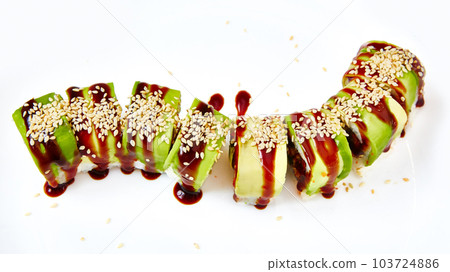 uramaki sushi roll with smoked eel unagi covered by avocado and sesame seeds on white background uramaki sushi roll with smoked eel unagi covered by avocado and sesame seeds on white background 103724886