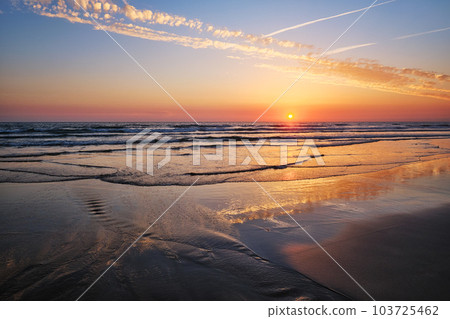 Atlantic ocean sunset with surging waves at Fonte da Telha beach, Costa da Caparica, Portugal 103725462