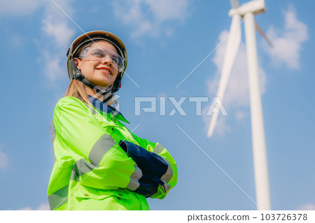 Professional engineer technician working outdoor at wind turbine field 103726378