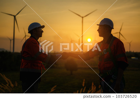 Professional engineer working with teamwork at wind turbine field Professional engineer working with teamwork at wind turbine field 103726520