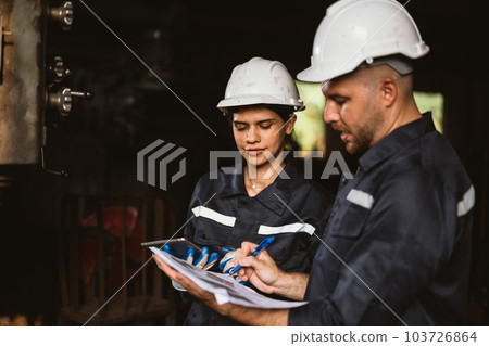 Two technicians engineers workers holding tablet checking Two technicians engineers workers holding tablet checking 103726864