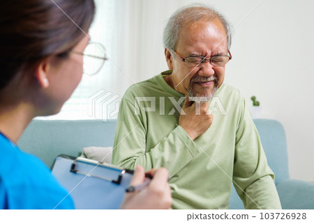 Caregiver nurse taking care of elderly grandfather sitting on sofa at home 103726928