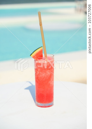 Refreshing cold tropical watermelon fruit juice smoothie on table 103727006