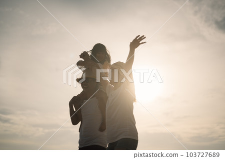 Happy Asian family travel on beach on holiday Happy Asian family travel on beach on holiday 103727689