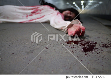Scary woman in white dress with bloodstain after murder, Halloween concept Scary woman in white dress with bloodstain after murder, Halloween concept 103727690