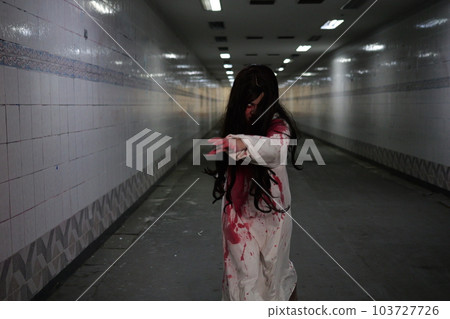 Scary woman in white dress with bloodstain after murder, Halloween concept 103727726
