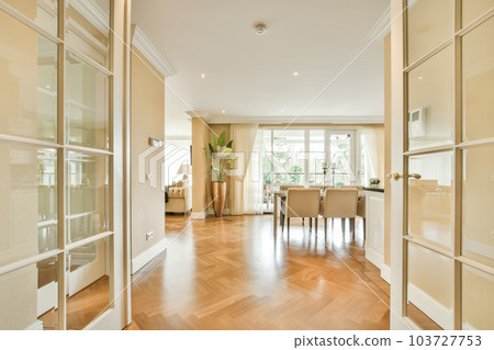 a living room with wood flooring and glass doors leading to the dining area in the room is very clean 103727753