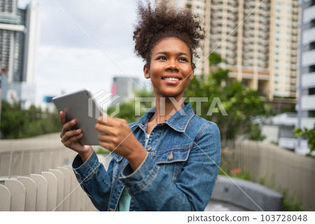 Smiling happy woman walking on street with backpack in city Smiling happy woman walking on street with backpack in city 103728048