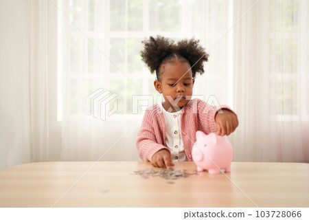 Little girl putting coin of cash into ceramic piggy bank Little girl putting coin of cash into ceramic piggy bank 103728066