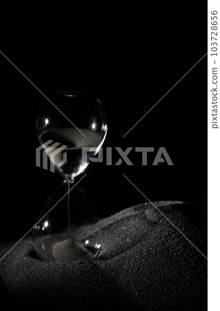 Hourglass stand on black sand with silhouette shadow over black background. Black hourglass show more time Deadline extended time management hope concept hour glass, life clock passing by 103728656