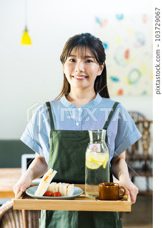 Young woman working at a fashionable cafe in the suburbs 103729067