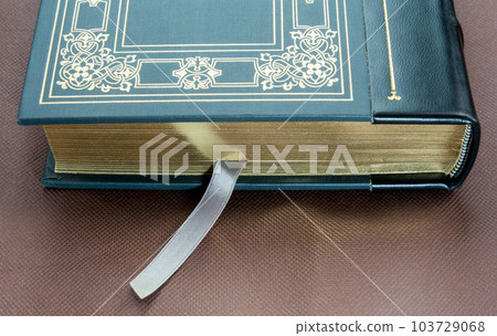 A green book with a gold-plated edge A green book with a gold-plated edge 103729068
