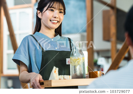 Young woman working at a fashionable cafe in the suburbs 103729077